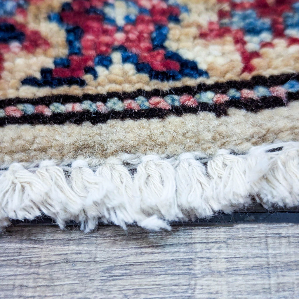 Close-up of short pile fringe on a Reperch wool area rug.