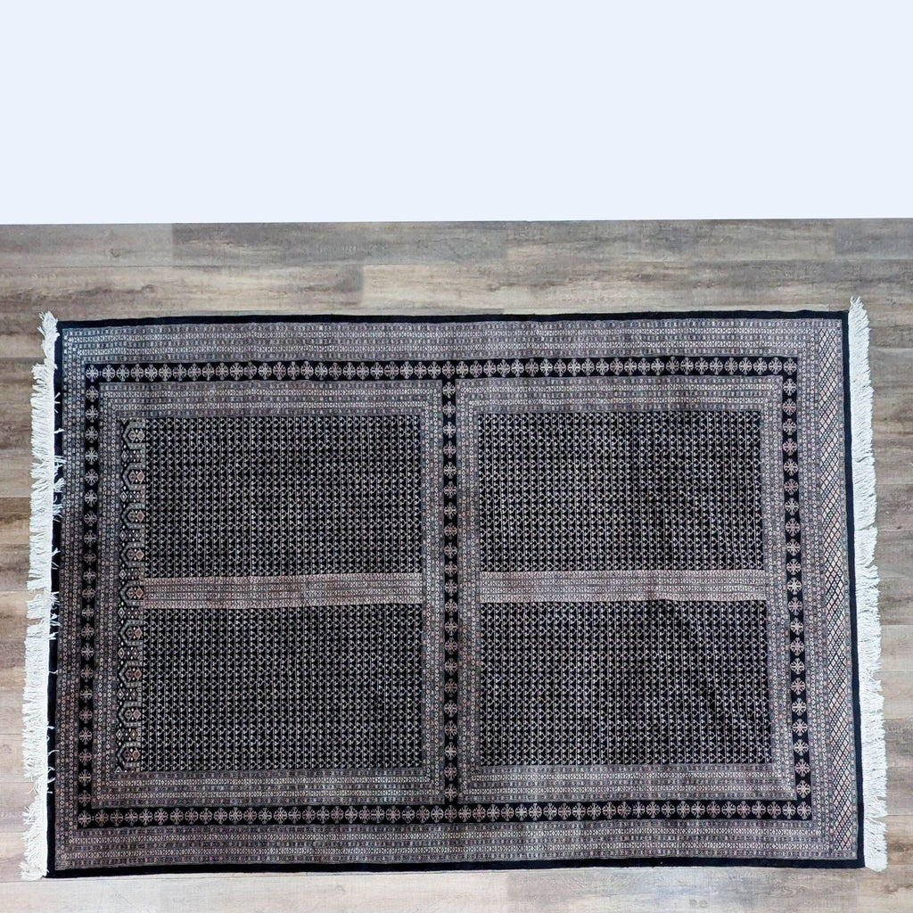 Hand knotted wool rug from Pakistan on a wooden floor.
