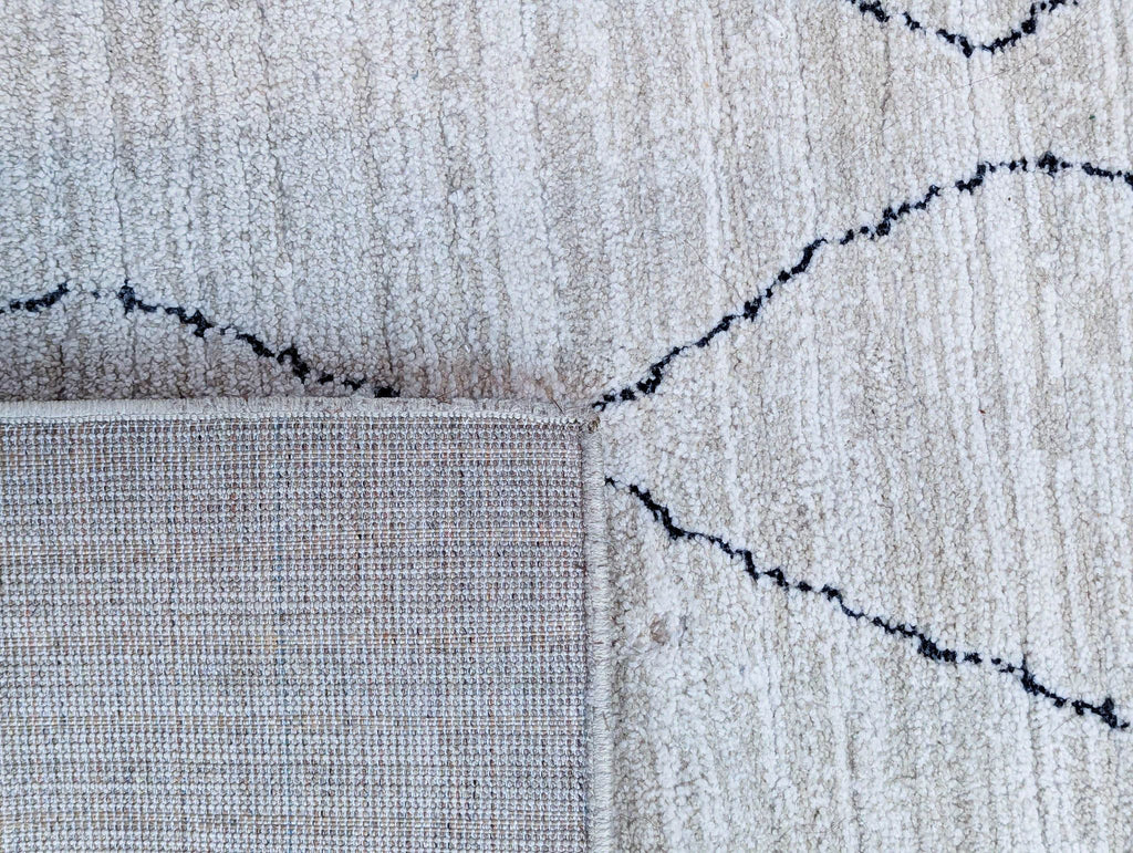 Detail of Loloi rug edge, showing woven polyester texture.