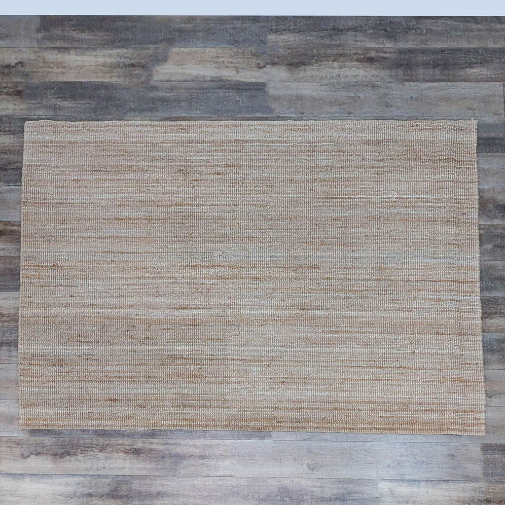 Flat woven neutral jute rug on wooden floor, Ikea brand.