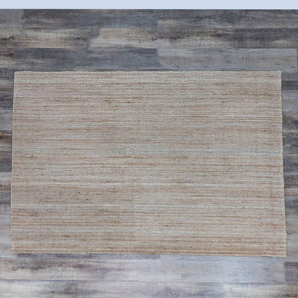 Flat woven neutral jute rug on wooden floor, Ikea brand.