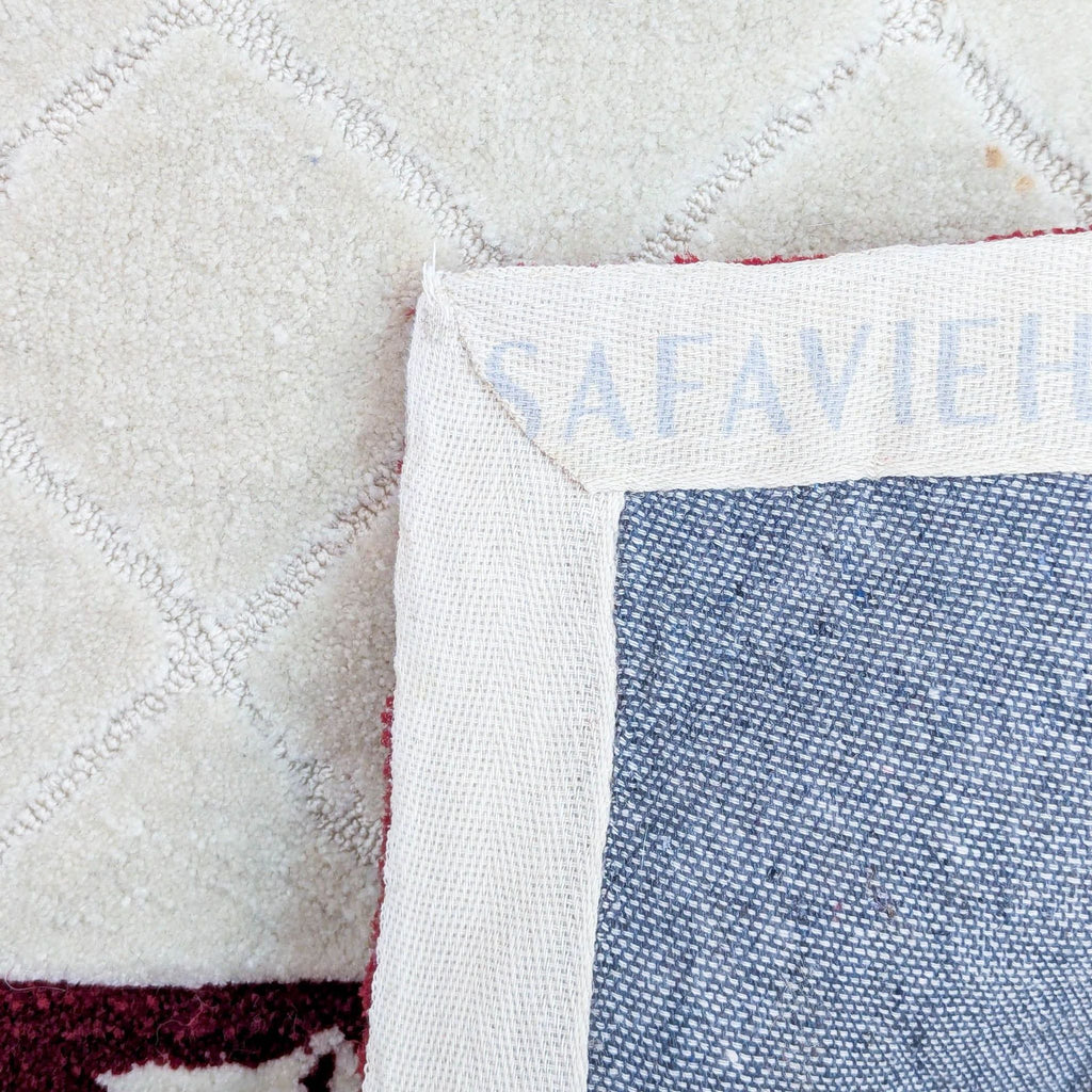 Close-up of Safavieh rug edge showing brand label and texture.
