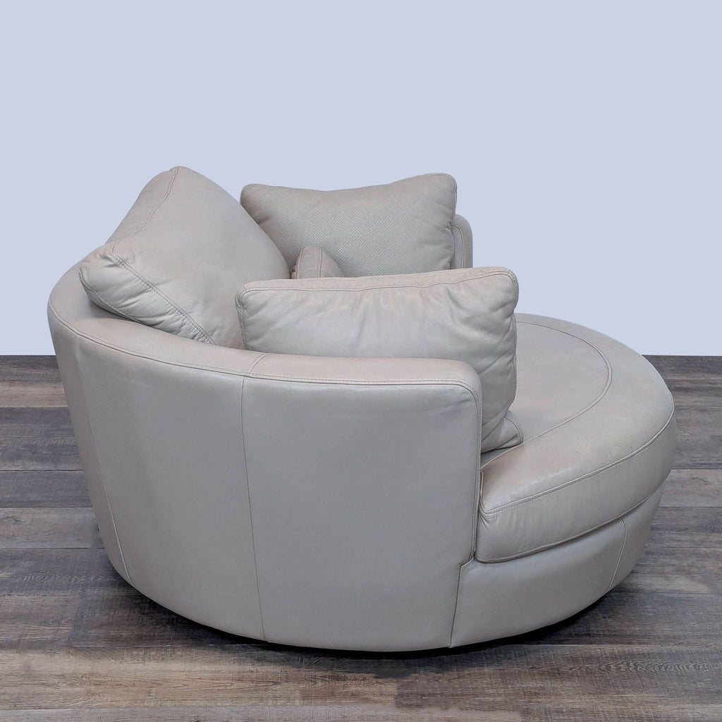 Side view of beige leather lounge chair with plush cushions.