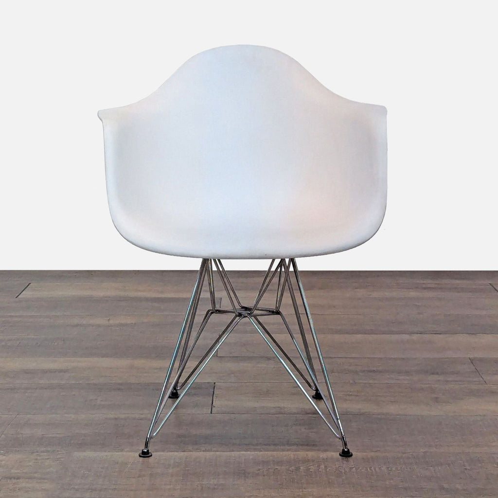 Front view of a modern chair with a molded plastic seat and chromed steel wire base.