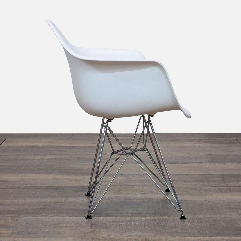 Side view of a white chair featuring a sleek plastic seat and Eiffel-style metal legs.