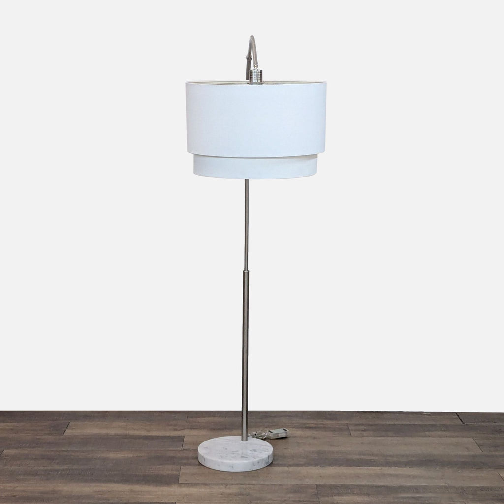 Elegant floor lamp, metal stand, crisp shade, and marble base perfect for lighting.