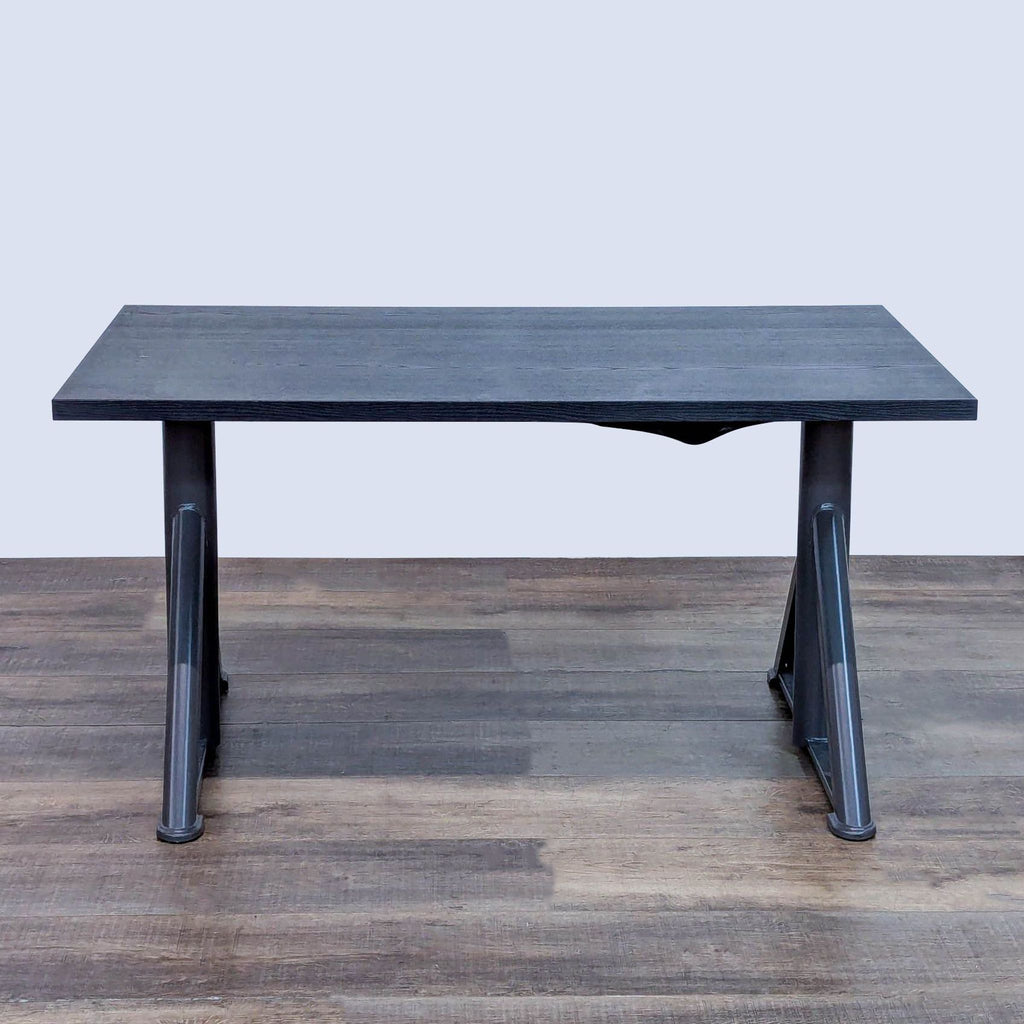 Adjustable height desk with cable management and durable veneer surface.