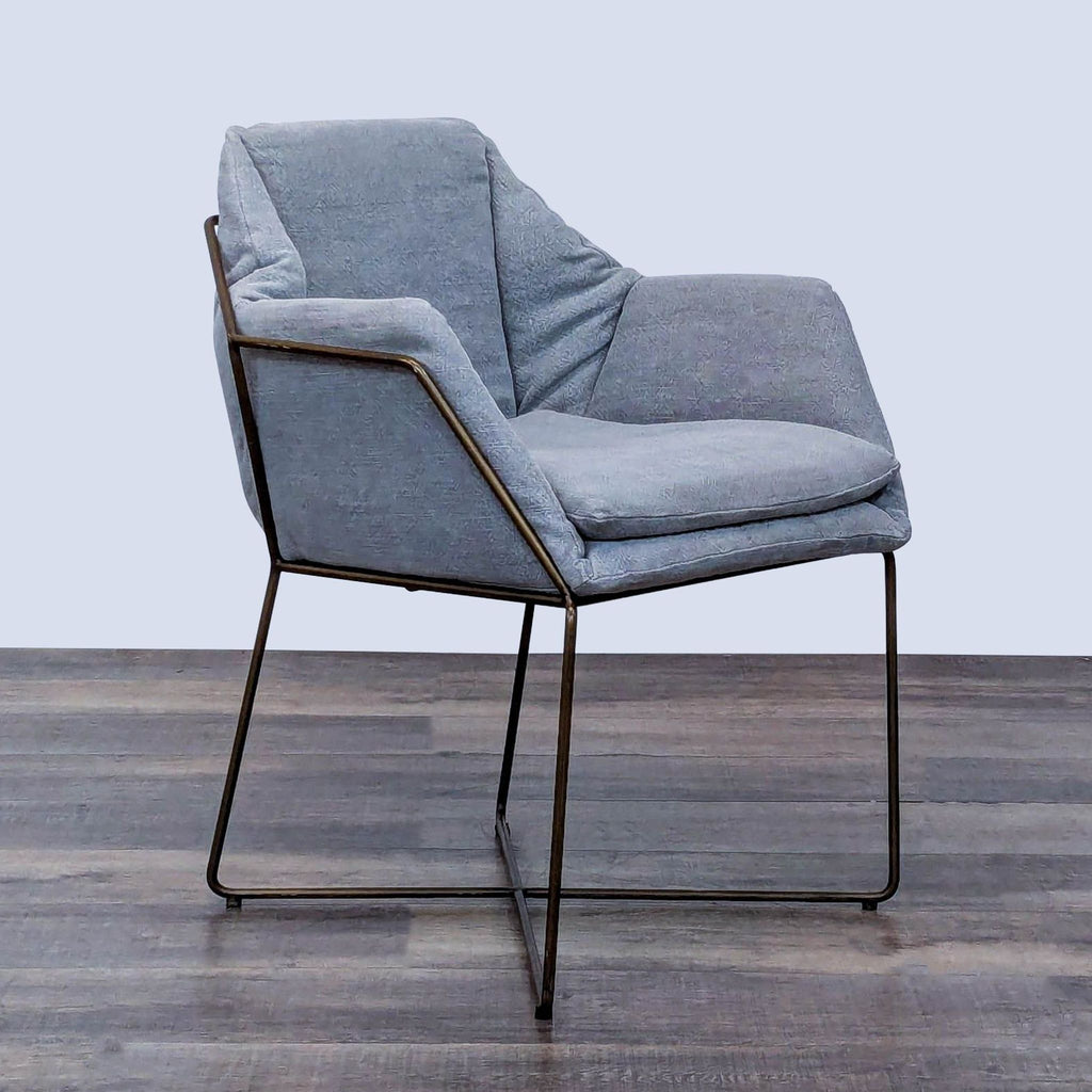 Angled view of a lounge chair with geometric metal frame and cushion.