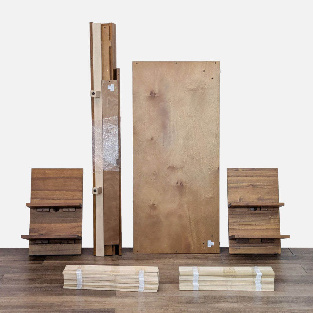 Disassembled parts of the Acacia platform bed, including wooden boards and shelves, displayed on the floor.