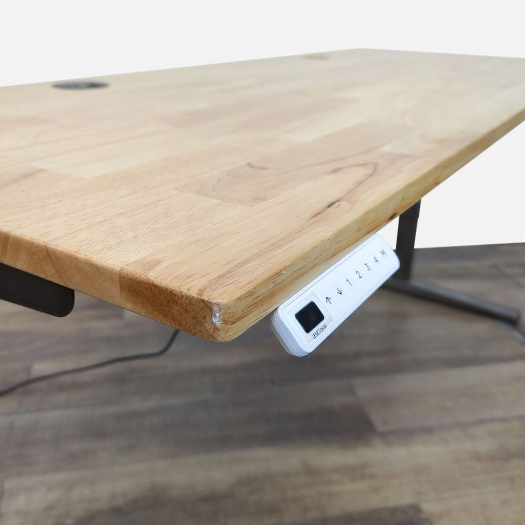 Close-up of the desk edge showing programmable keypad, from Uplift Desk.