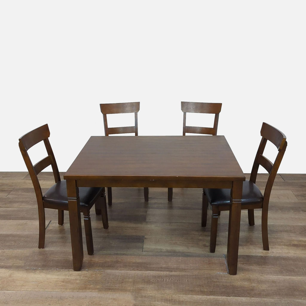 Reperch dining set featuring a table and four espresso-finished chairs with faux leather seats.