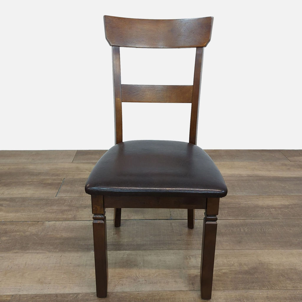 Reperch chair in espresso finish with a rich brown faux leather seat, part of a dining set.