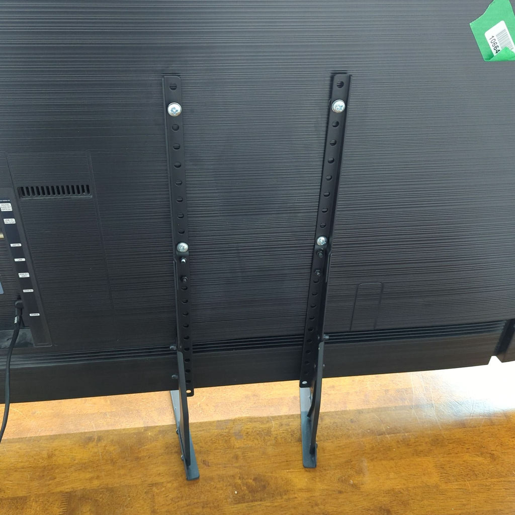 Back of a Samsung TV showing the mounting brackets and connections.