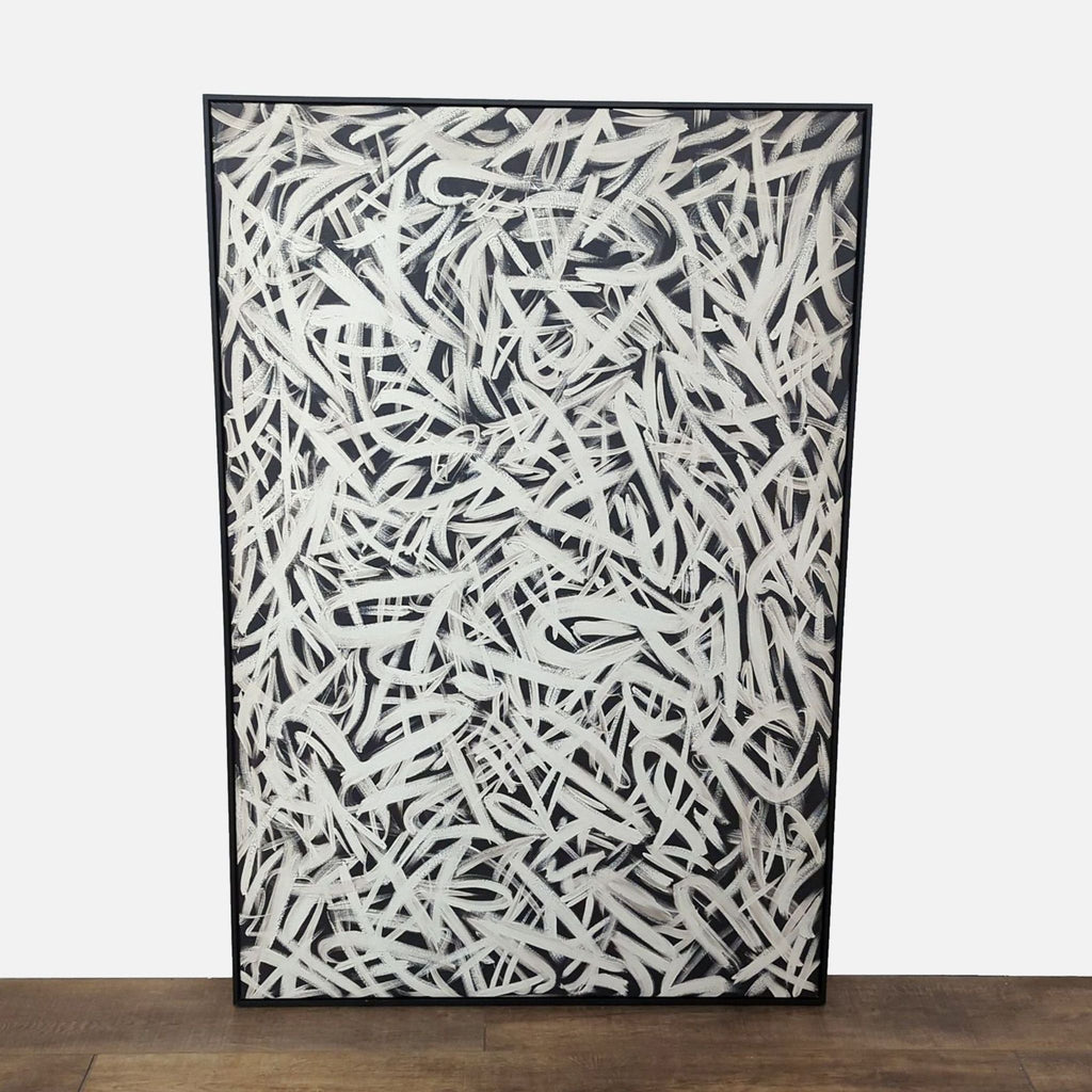 Abstract black and white canvas print in a sleek black frame.