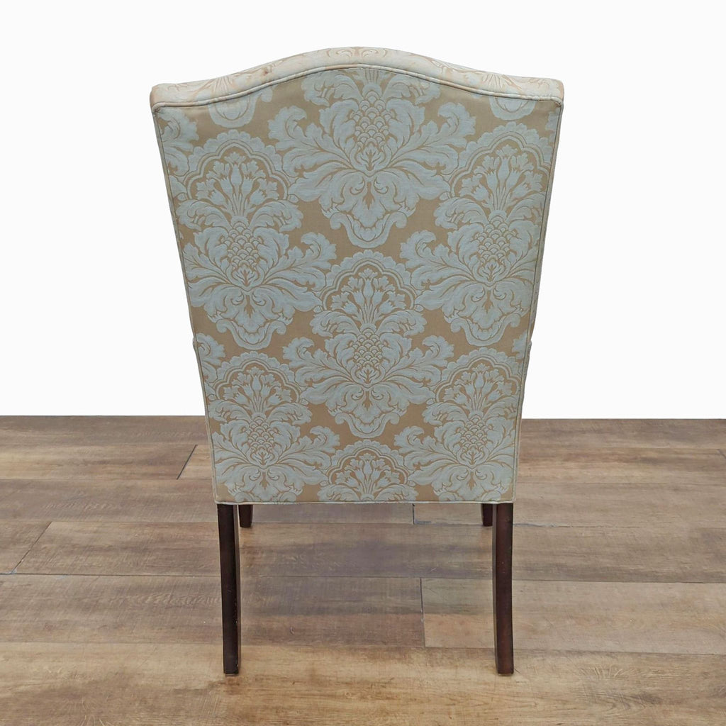 Back view of a dining chair featuring intricate upholstery design.