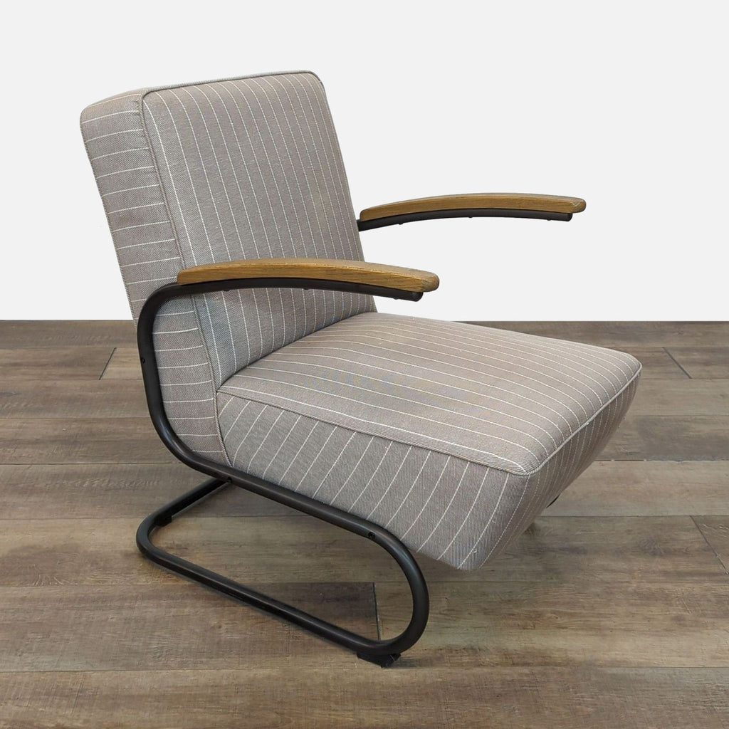 Side angle of a chair showing black iron tubing and pinstripe cushioning.