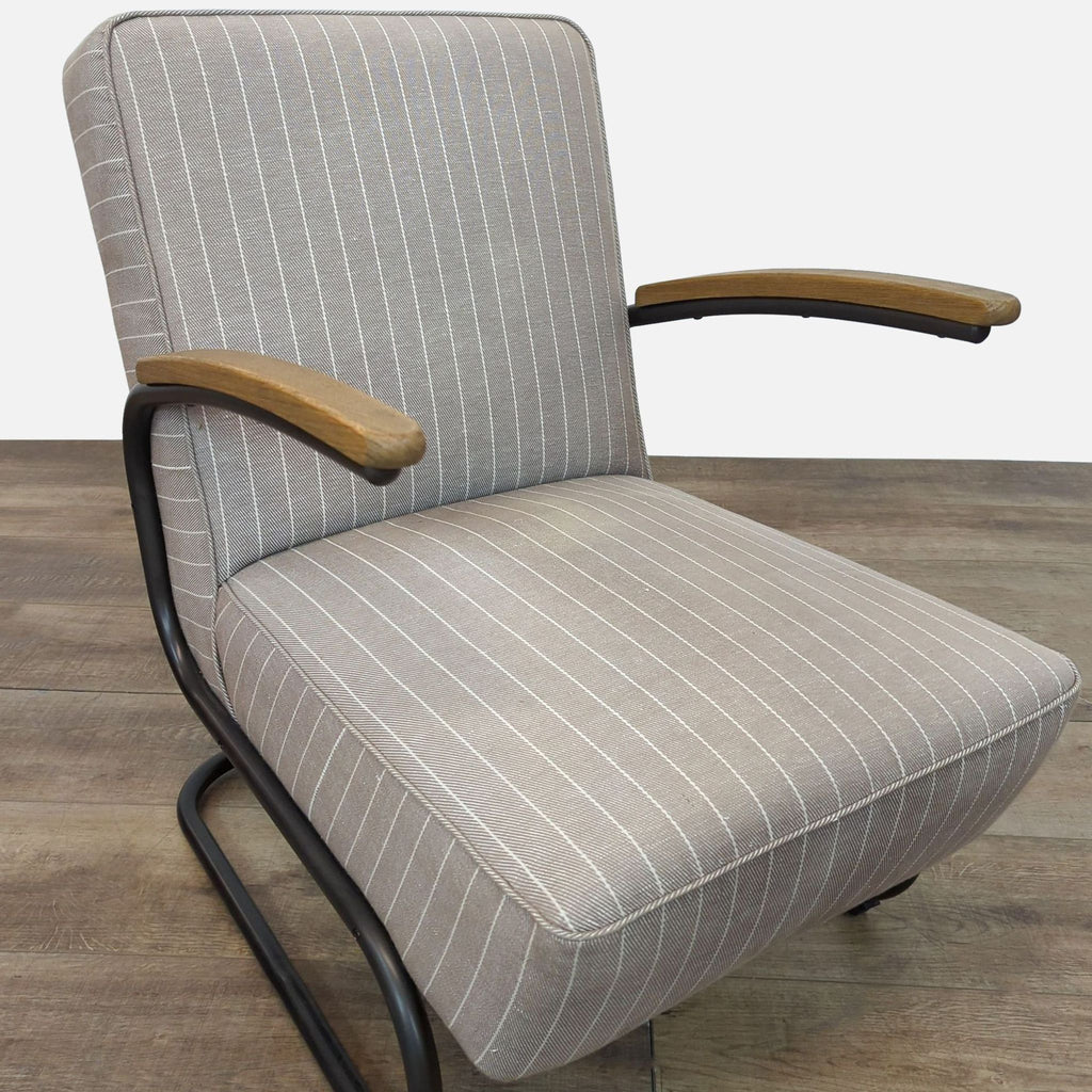 Perspective shot highlighting the chair's oak arm rests and pinstripe design.