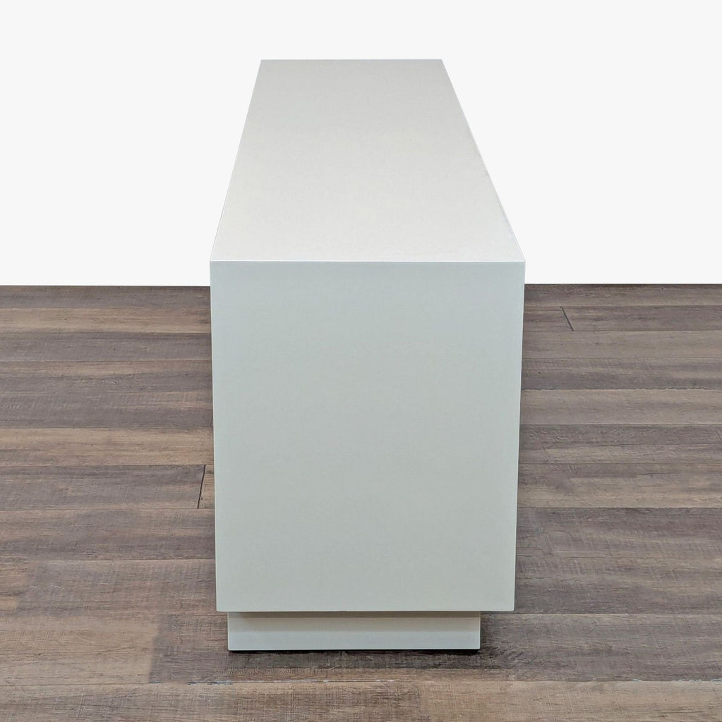 Side profile of the sleek Ivory Lacquer Entertainment Center highlighting its modern, clean lines.