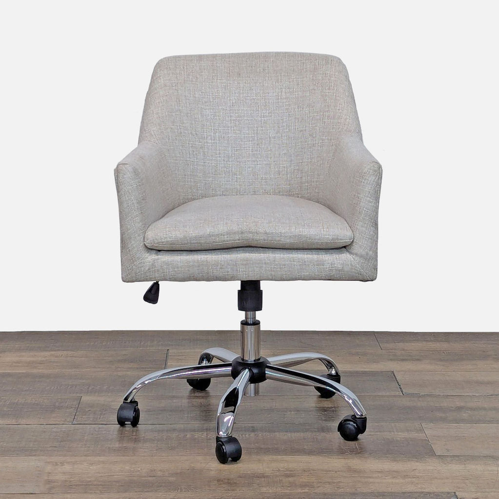 Mid-century chair with cushy seat, chrome base, and wheels.