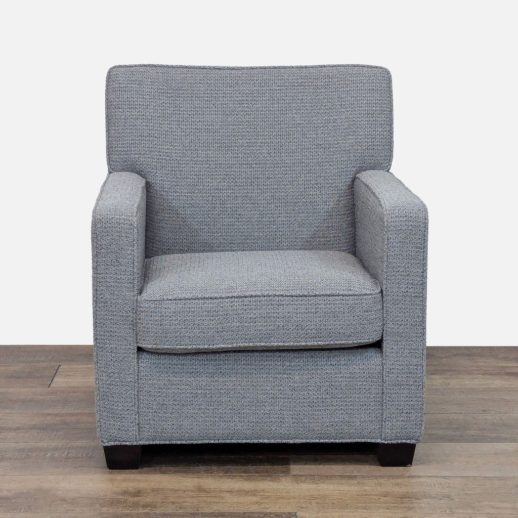 Gray lounge chair with track arms, fabric upholstery, and dark wood feet by Reperch.
