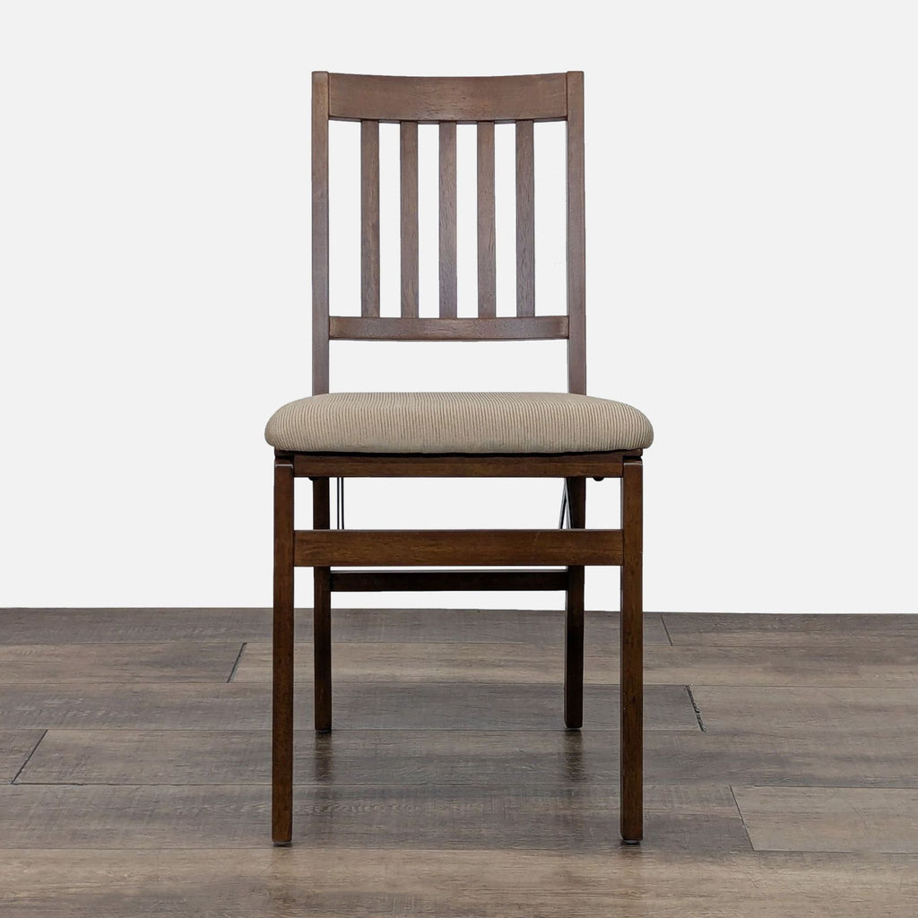 Front view of Reperch dining chair with cushioned seat and slatted back.