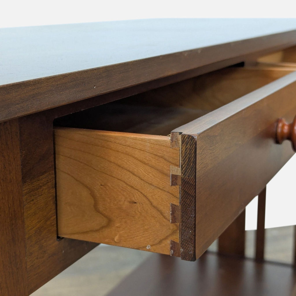 Close-up of wooden drawer detailing on a console table.
