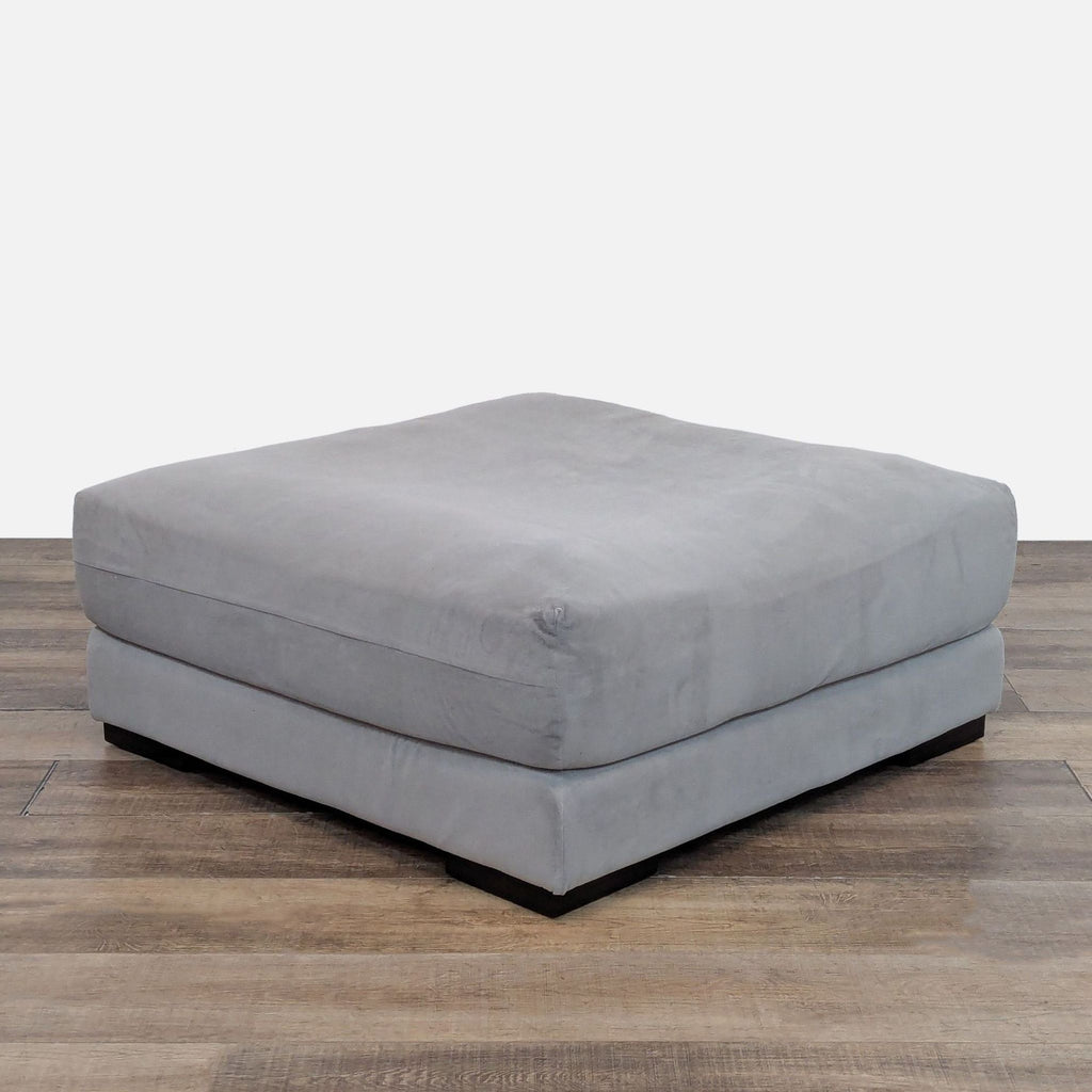 Square ottoman with silver performance fabric, West Elm design.