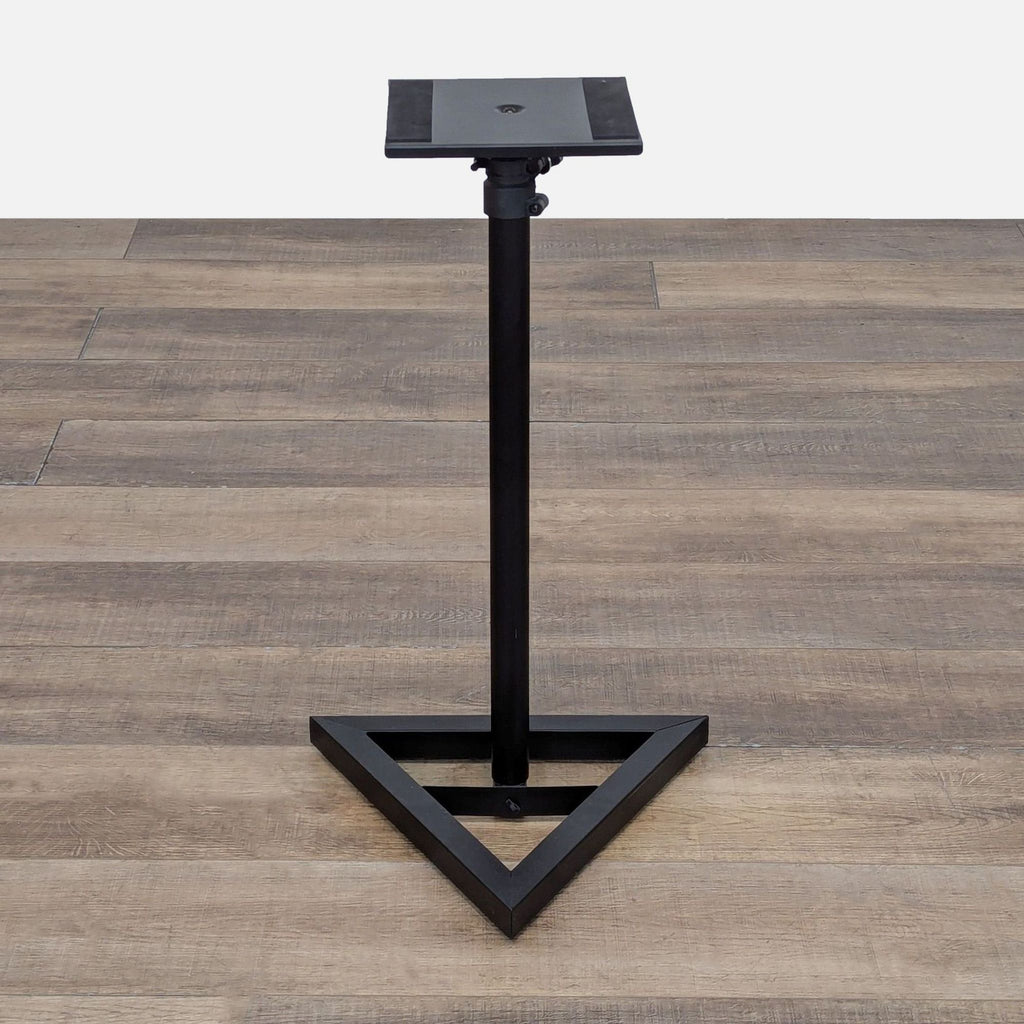 Sturdy black speaker stand with adjustable height and triangle base for stability.