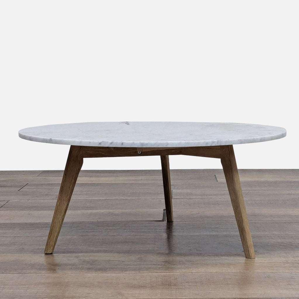 Mid-Century modern coffee table with oak legs and a polished marble top.