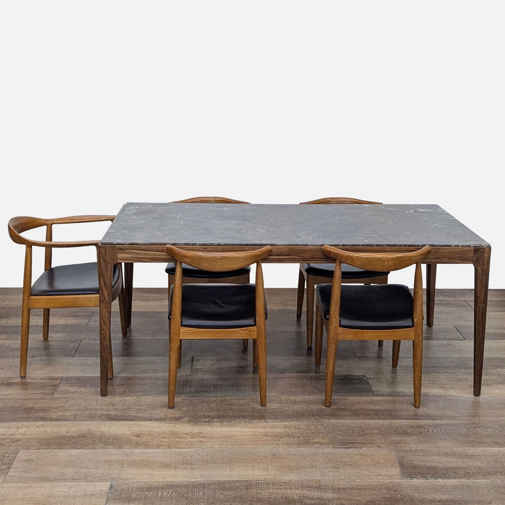 Rectangular marble dining table with mid-century chairs.