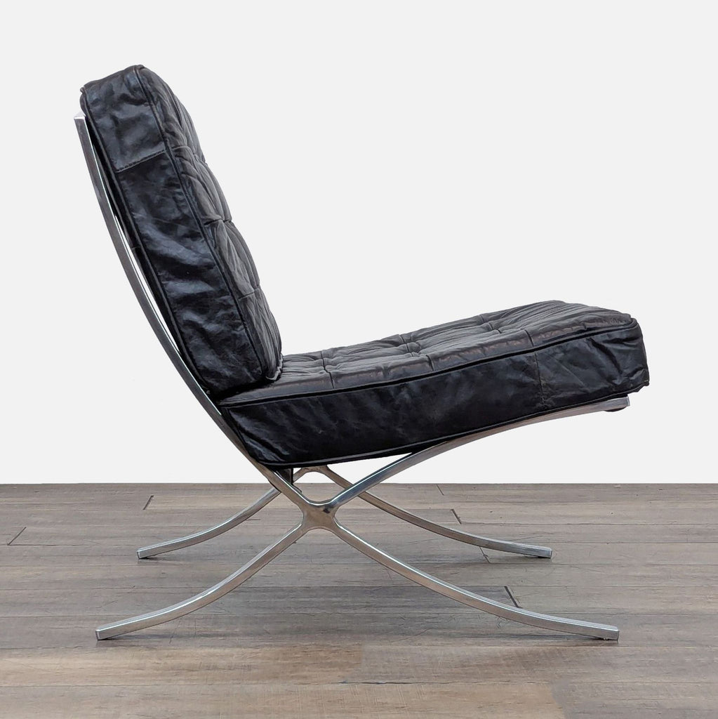 Side view of the Barcelona chair, showcasing the sleek stainless steel frame and leather cushions.
