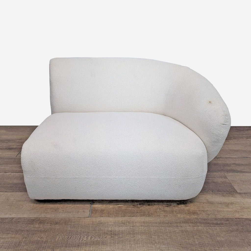 Modern cream sofa with curved design and tightback armrests. Upholstered in boucle fabric.