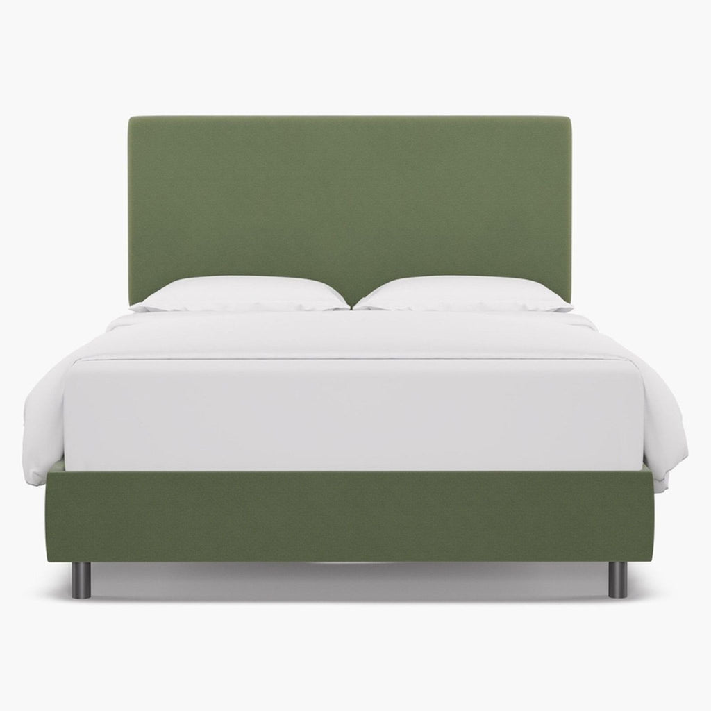 Green velvet upholstered bed frame with a tailored headboard.
