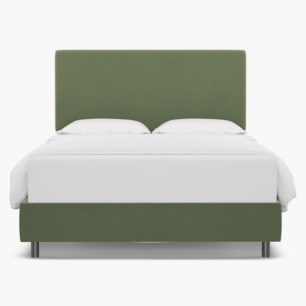 Green velvet upholstered bed frame with a tailored headboard.