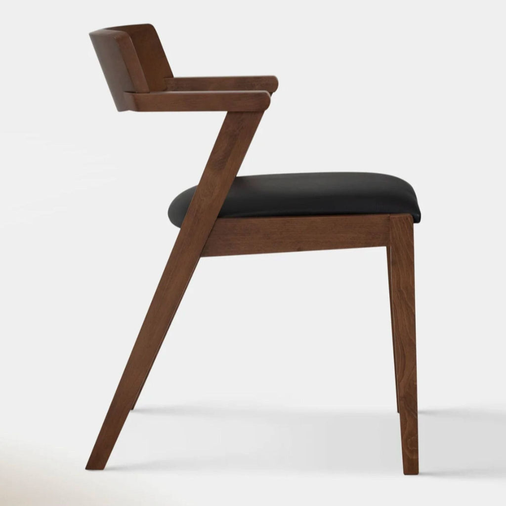 Side view of Zola chair featuring wooden frame and black leather seat, mid-century modern style.