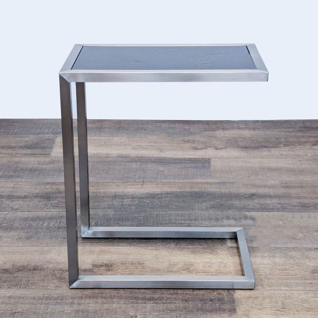 Minimalist Reperch End Table with rectangular top and open base.