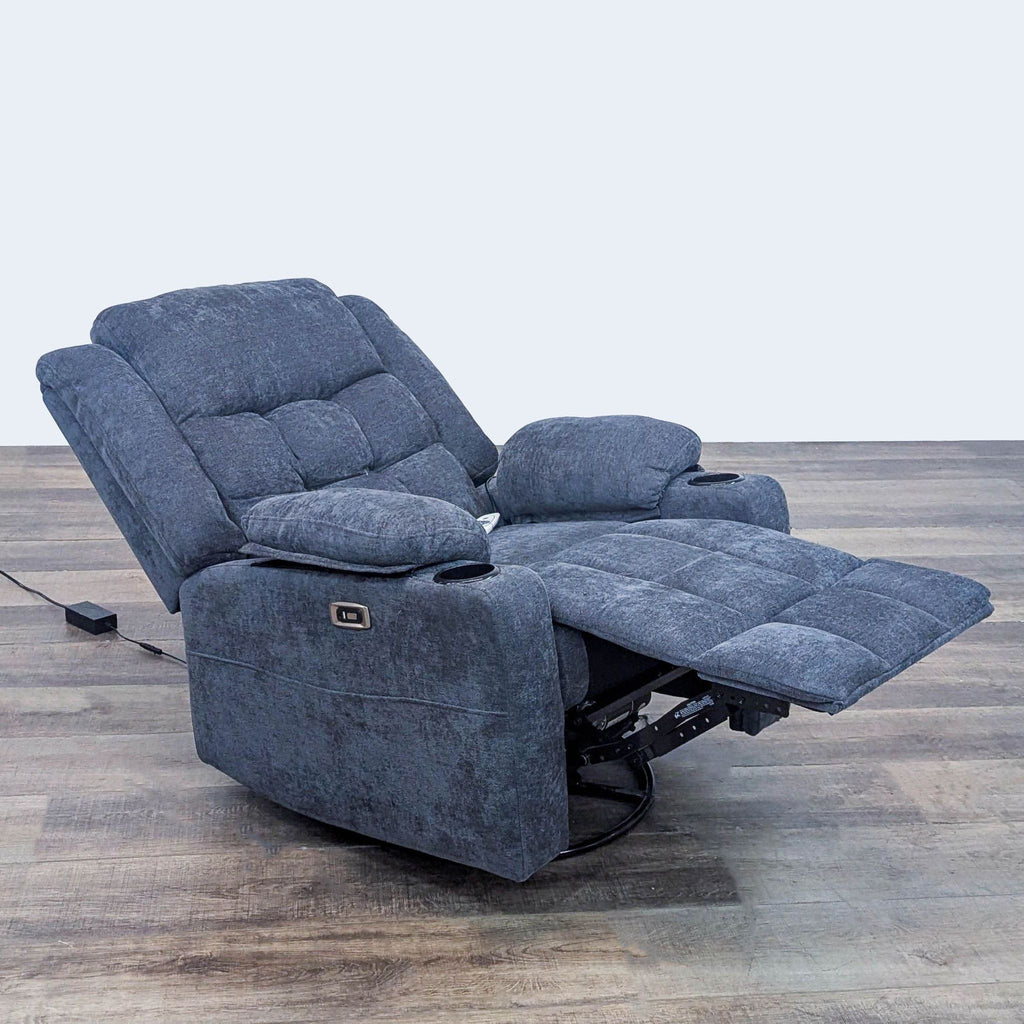 A comfy reclining chair featuring tufted cushions, built-in cup holders, USB, and remote. Reperch Lounge.