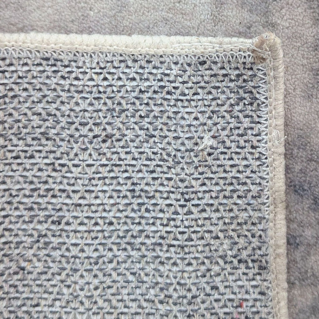 3. View of the non-slip backing on the Reperch rug, emphasizing durability and easy maintenance.