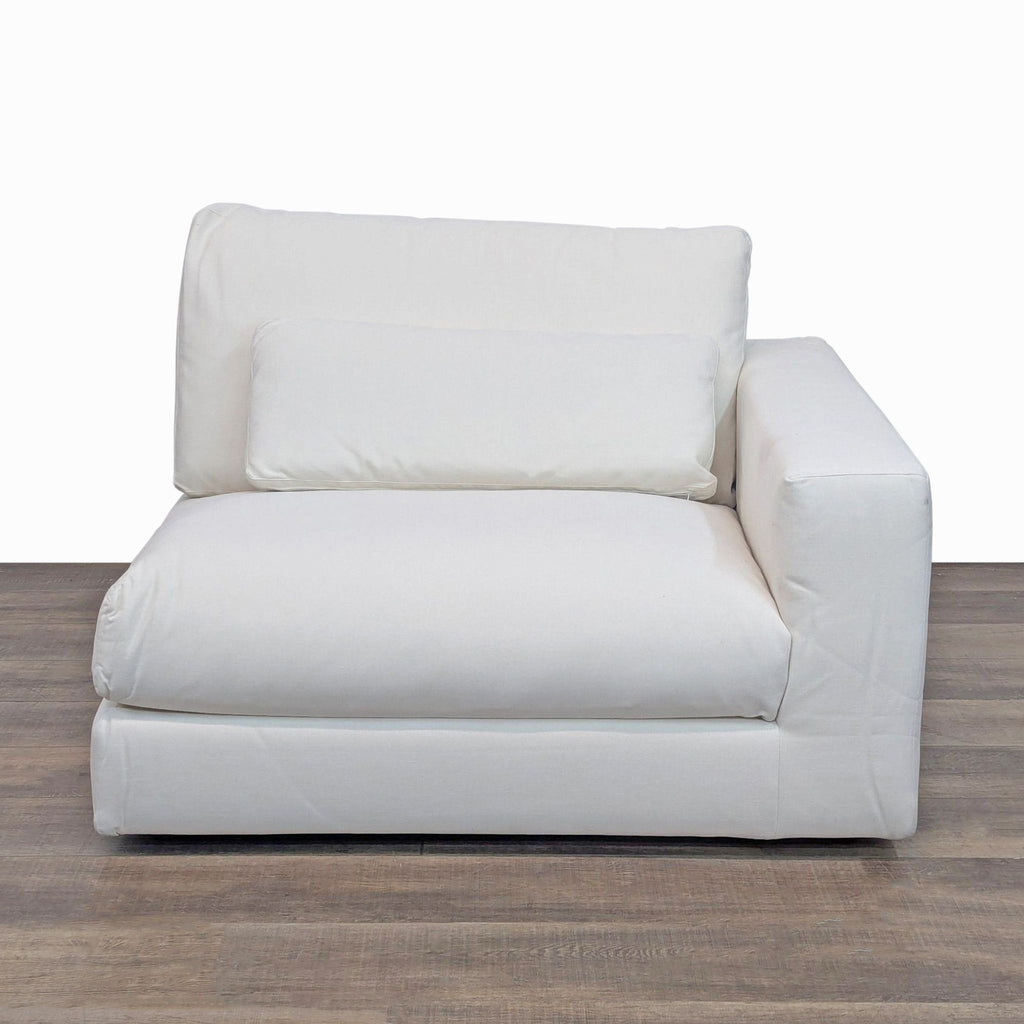 Modular chair with right track arm and thick cushions, featuring a washable slipcover.