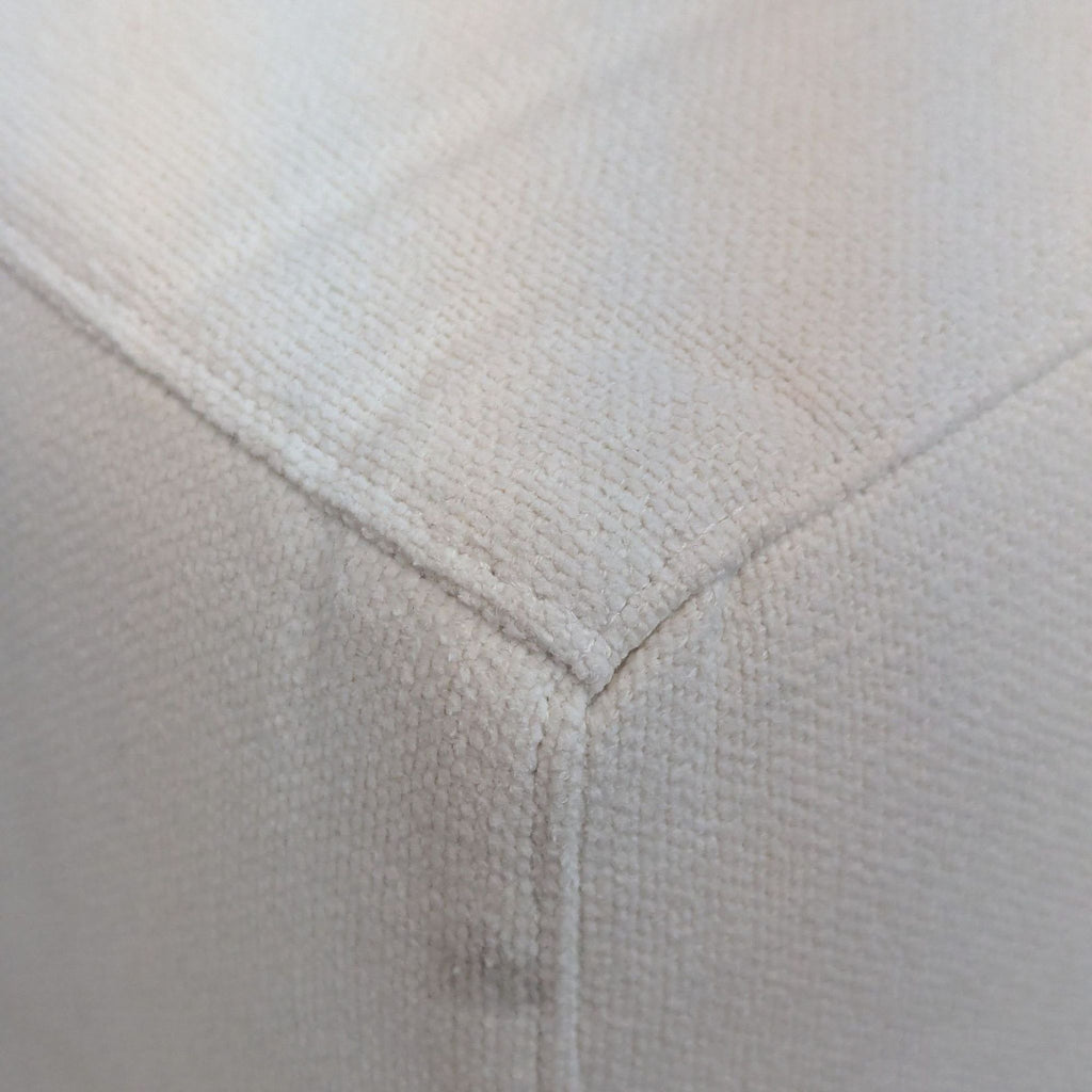 Close-up of the fabric texture on a modular chair's slipcover, showing fine weave details.
