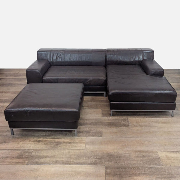 IKEA sectional with leather upholstery on metal base, positioned on wooden floor.