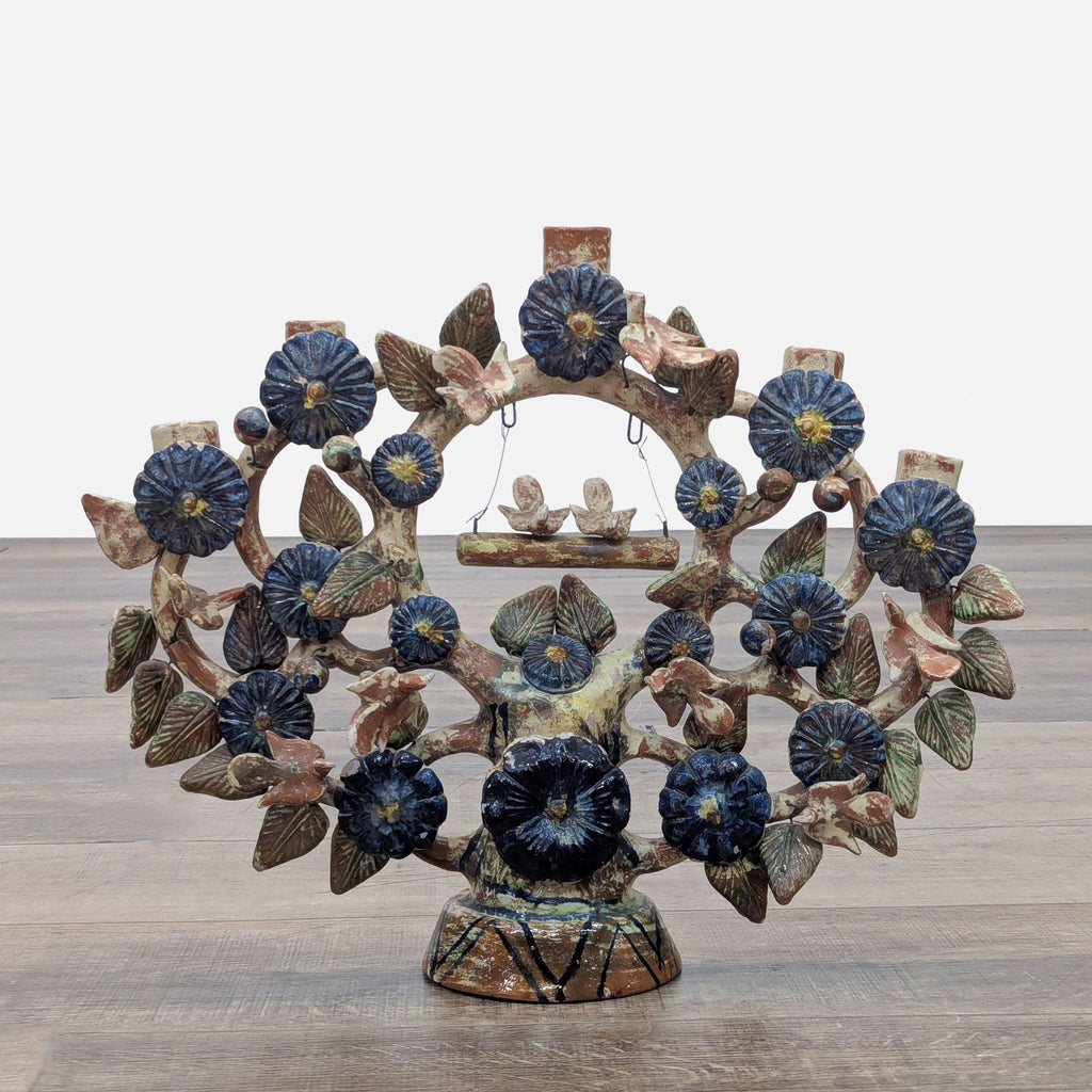 Mexican folk art with glazed flowers, birds, and five candle holders in a floral design.