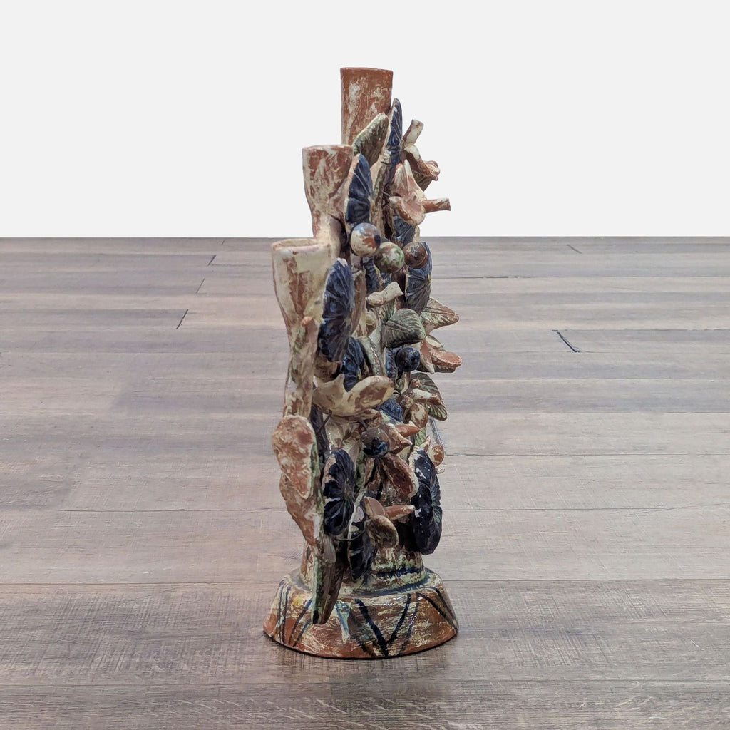 Side view of Mexican folk art with glazed flowers and birds, showcasing its layered structure.