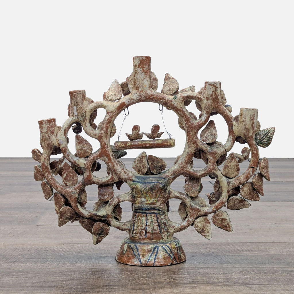 Back view of a decorative Mexican folk art piece with branch and flower motifs.