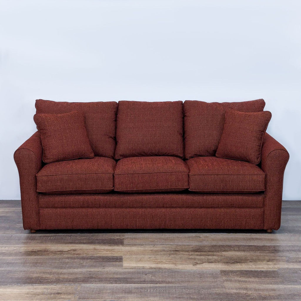 Red textured Reperch sleeper sofa with plush cushions and accent pillows.	
