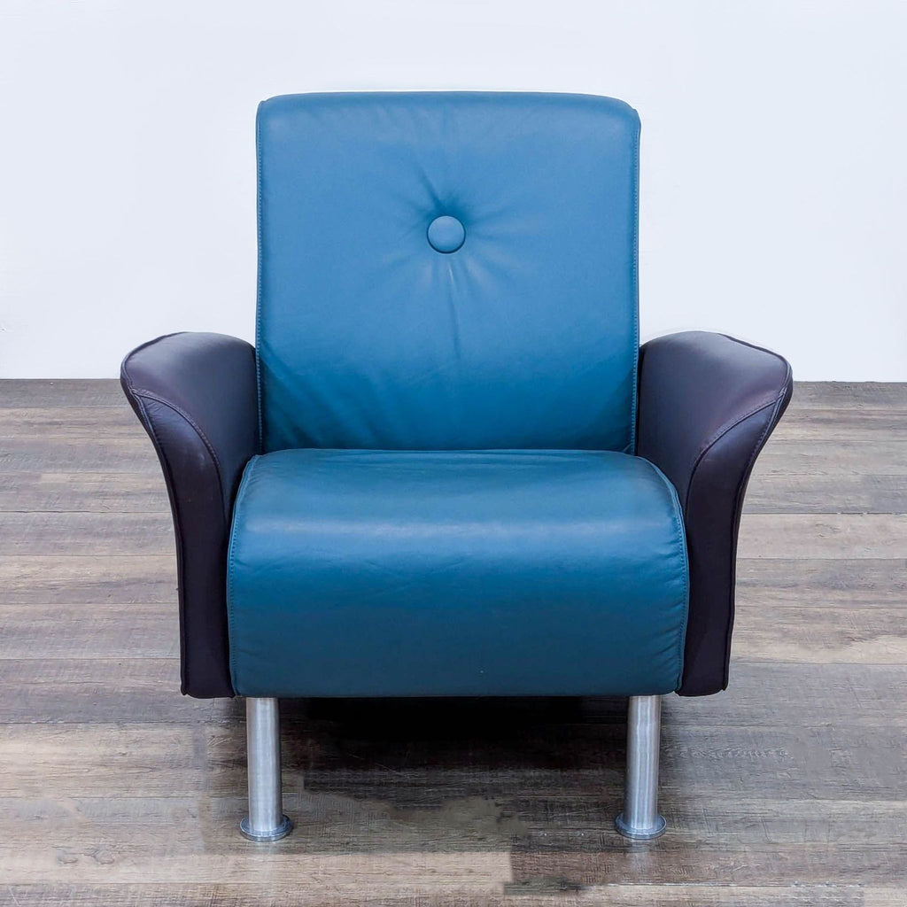 Blue leather chair with metal legs, part of VIA Inc.'s lounge collection.