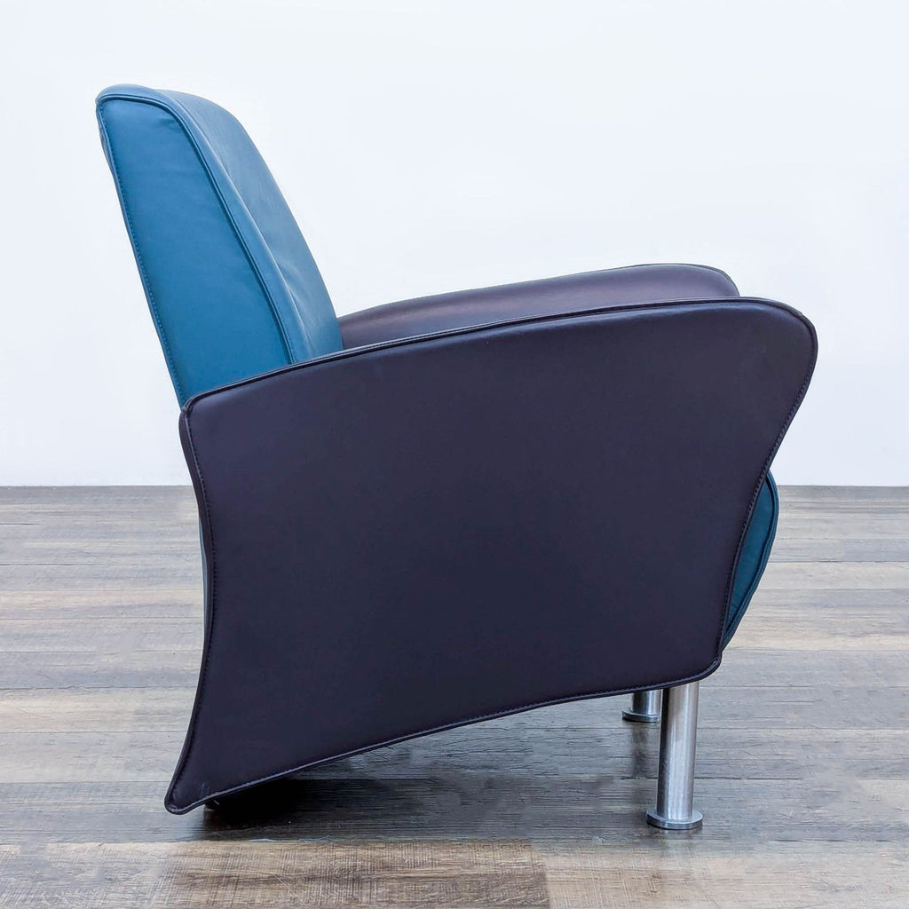 Side view of a blue leather lounge chair with sleek metal legs, by VIA Inc.