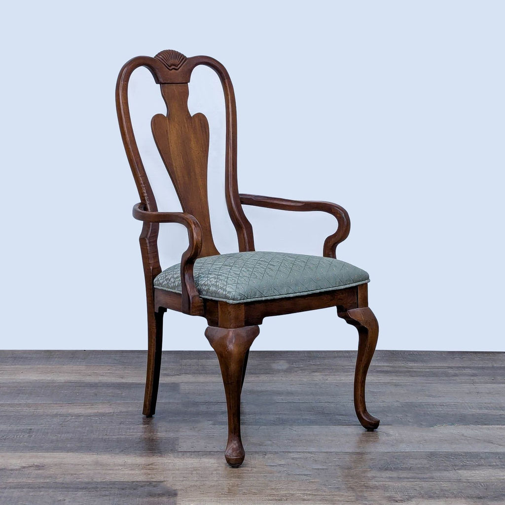 Side view of a Drexel Heritage chair showing detailed woodwork and green patterned upholstery.