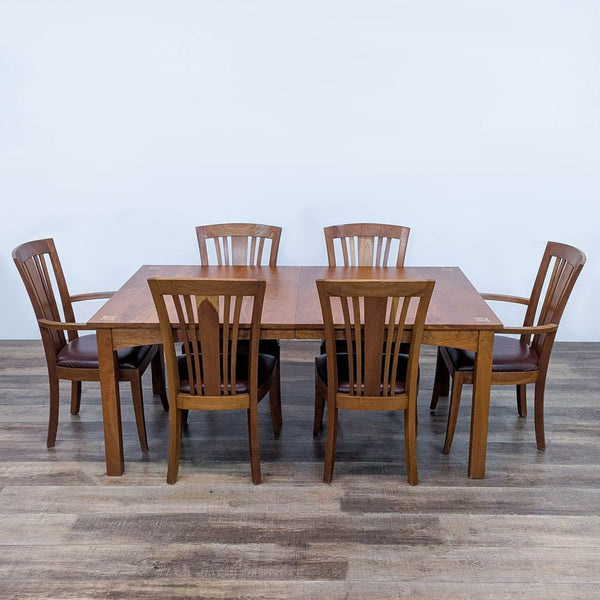 1. Stickley cherry dining set with six chairs, leather seats, and intricate wood inlays on the table corners.  