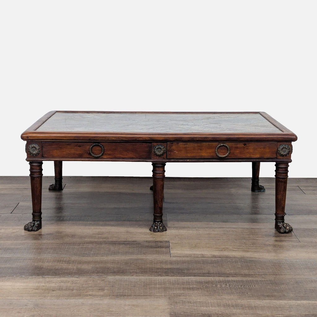 Reperch coffee table with metal paw feet and dual drawers, each opening on opposite sides.